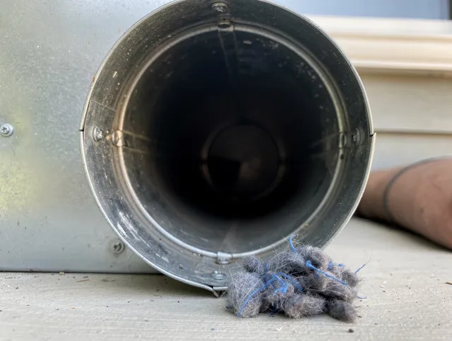 Naugatuck Dryer Vent Cleaning technician using specialized equipment to clear severe dryer vent blockage in Naugatuck
